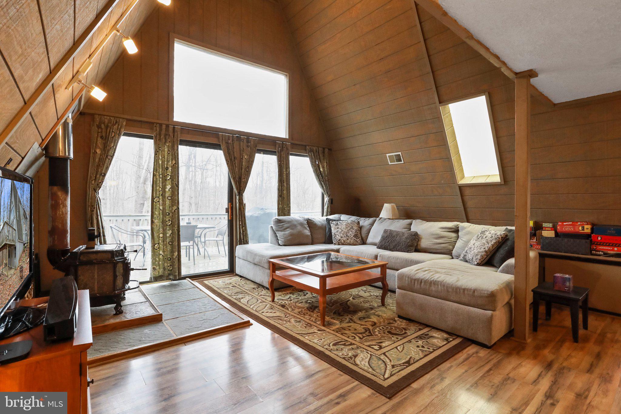 13 Mountainside Loop Berkeley Springs, WV 25411 - Photo 10 of 57 a living room with furniture and a floor to ceiling window