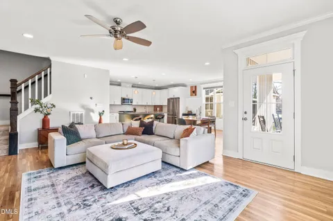 a living room with furniture ceiling fan and a rug