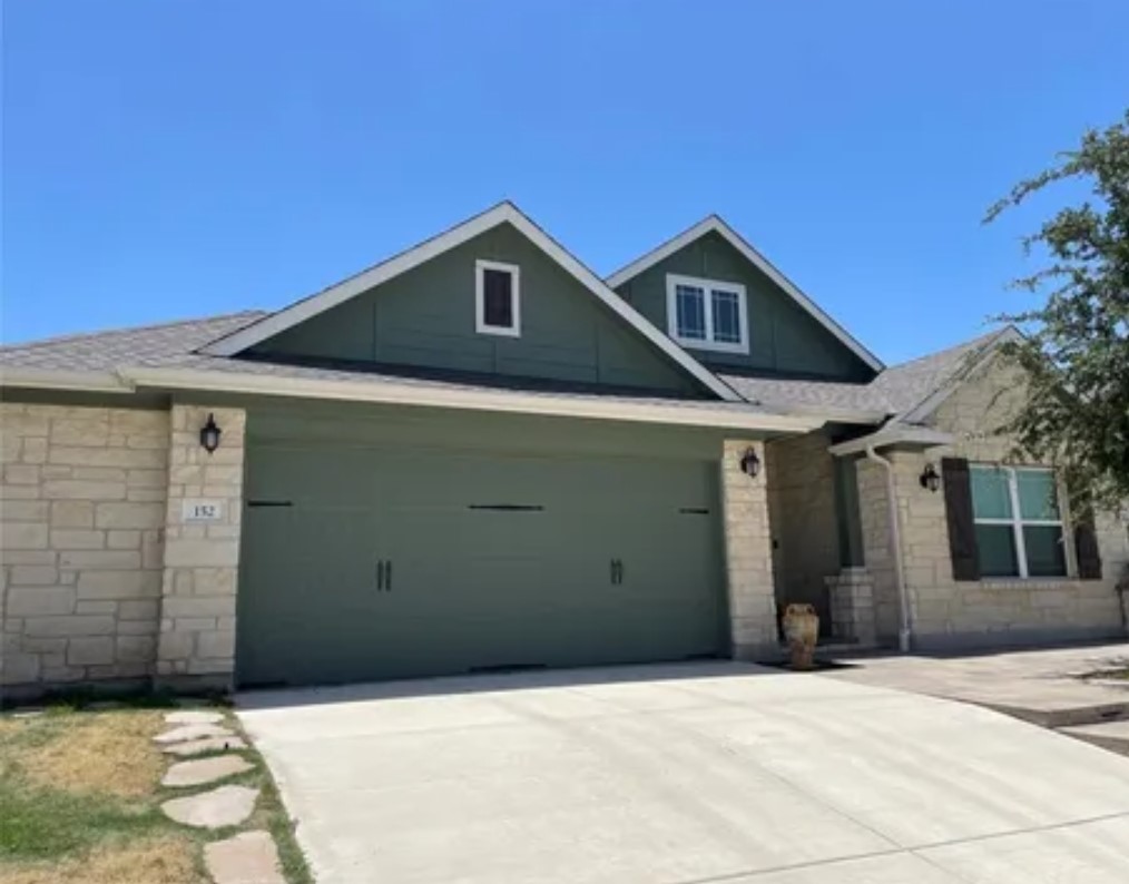 a front view of a house with garage