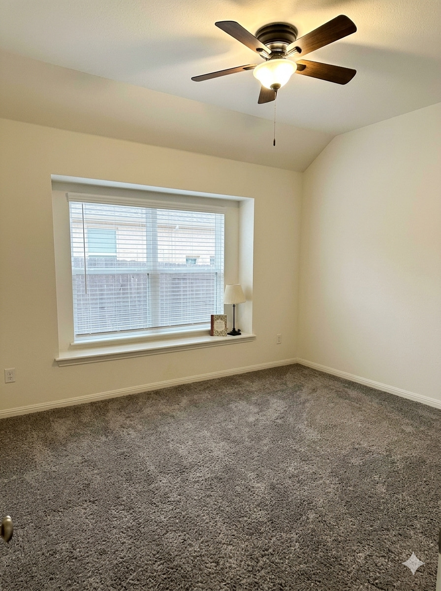 152 Venti Cove Georgetown, TX 78628 - Photo 14 of 16 an empty room with chandelier fan and windows