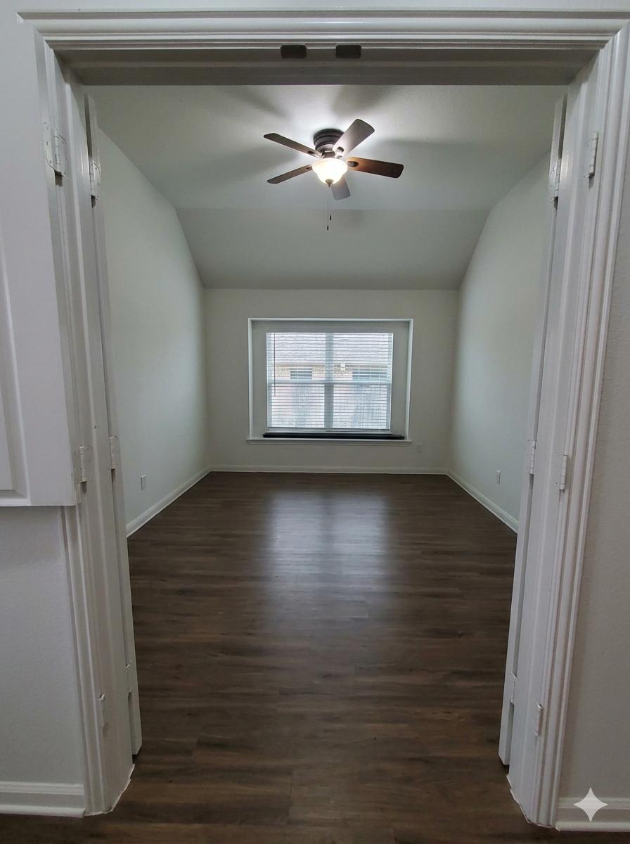 152 Venti Cove Georgetown, TX 78628 - Photo 16 of 16 a view of an empty room with wooden floor and a window