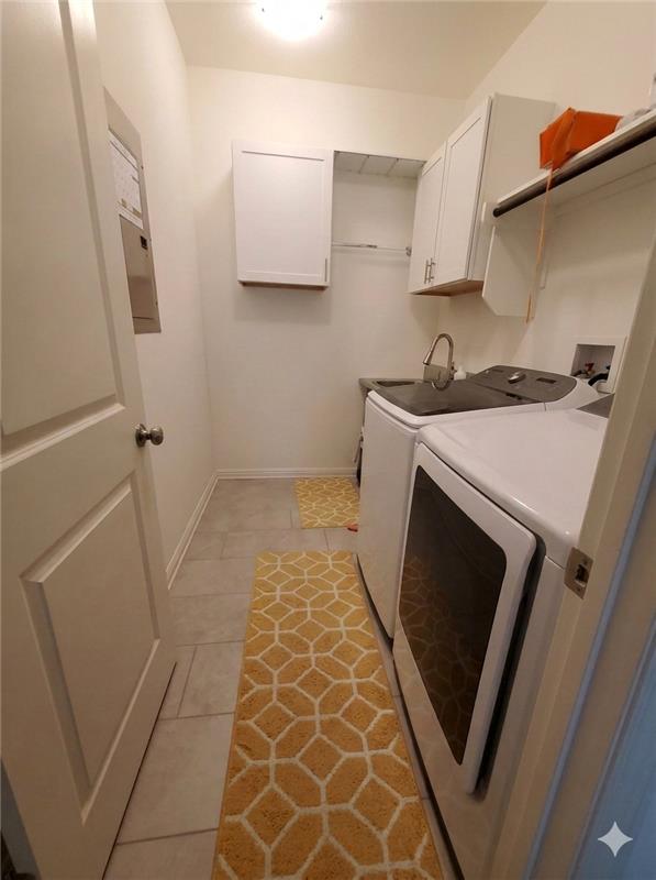 152 Venti Cove Georgetown, TX 78628 - Photo 5 of 16 a utility room with cabinets washer and dryer