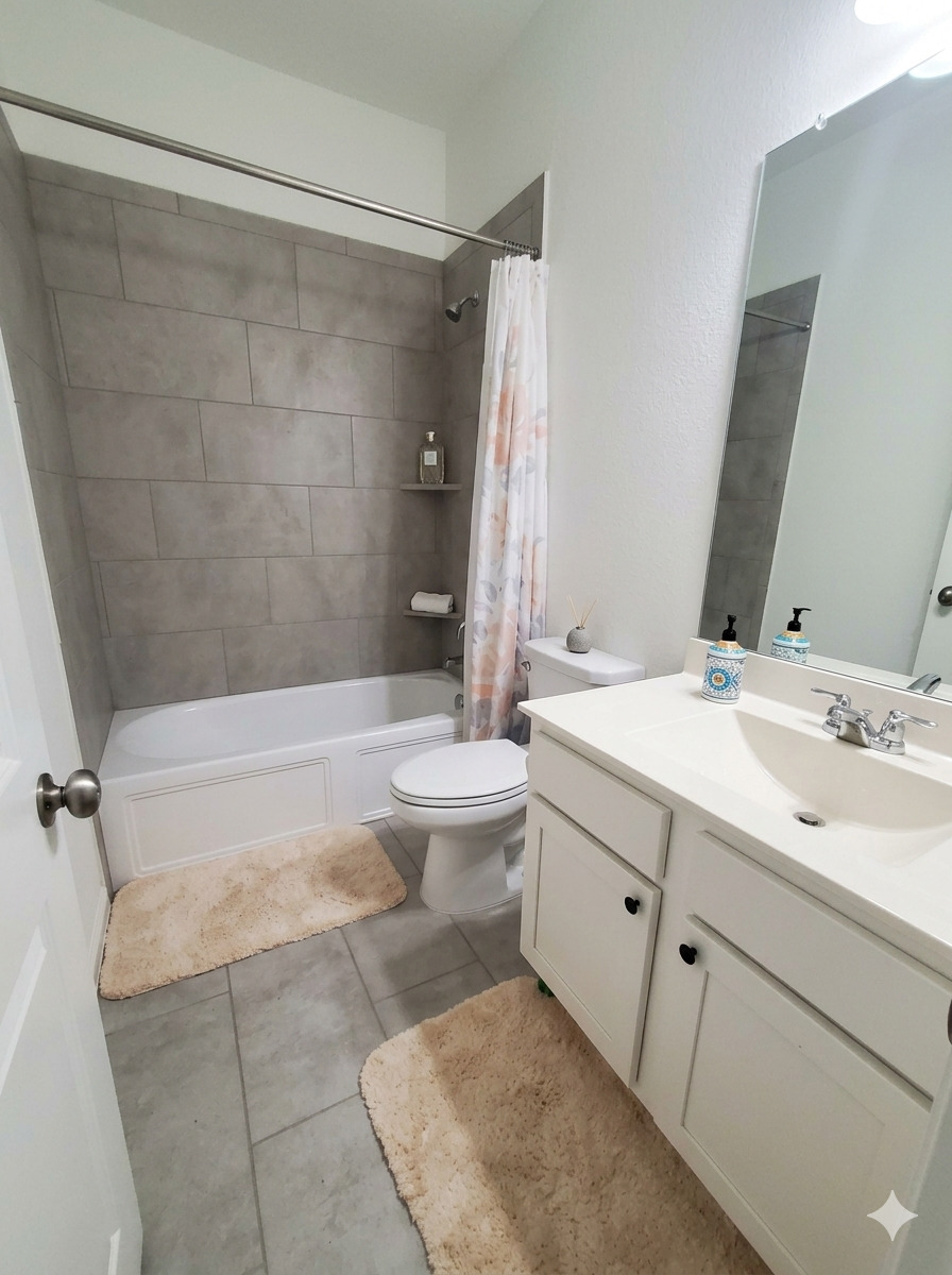 152 Venti Cove Georgetown, TX 78628 - Photo 8 of 16 a bathroom with a double vanity sink toilet and shower