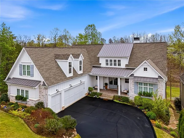 a view of a house with potted plants and a large window