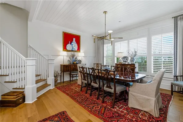 a living room with furniture a fireplace and a chandelier