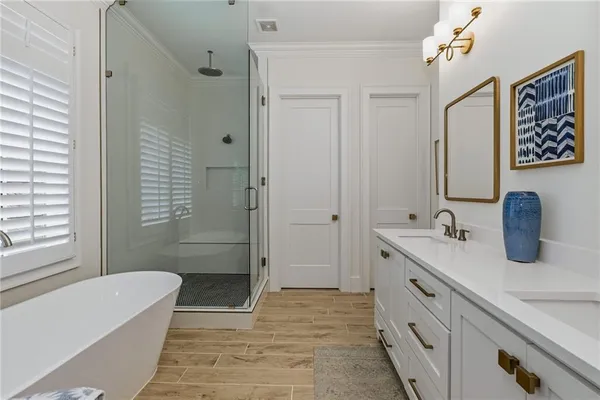a bathroom with a sink a toilet a mirror a vanity and shower