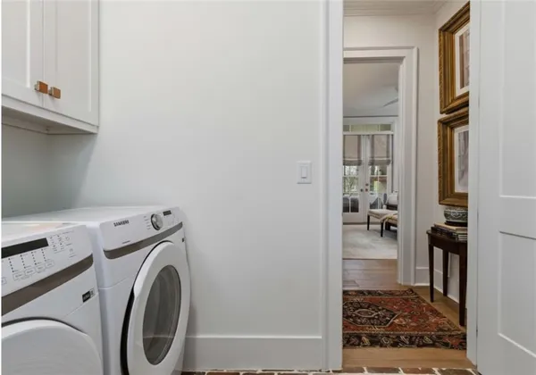a view of a patio with table and chairs potted plants and floor to ceiling window