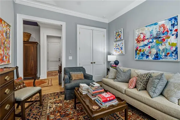 a front view of a house with a yard and potted plants