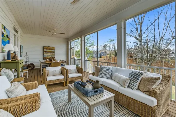 a view of a patio with chairs and a small yard