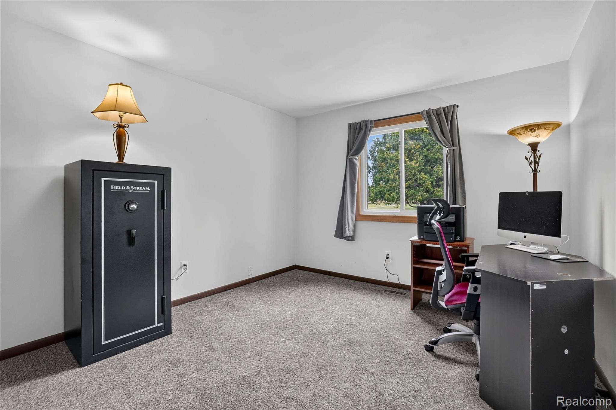 6895 Stow Road Fowlerville, MI 48836 - Photo 19 of 45 Neutral wall paint, wood-trim window, and grey carpeting