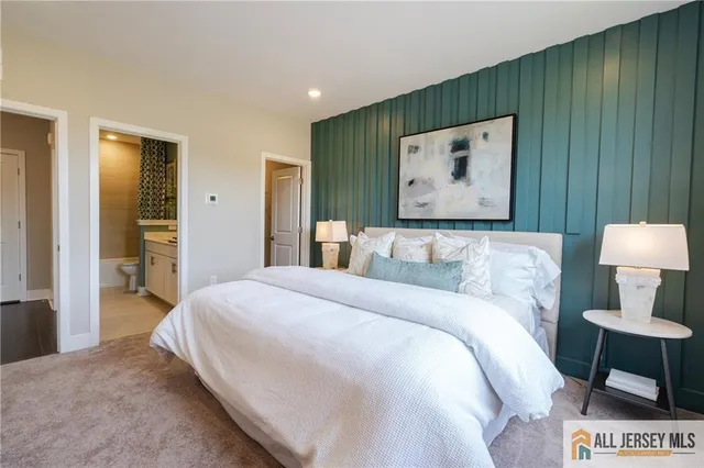 a bedroom with a bed and a dresser with mirror