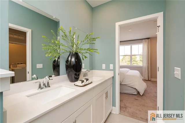 a large bed sitting in a bedroom next to a window