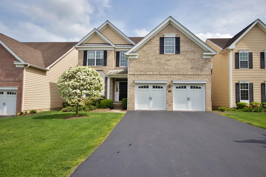 a front view of a house with a yard and garage