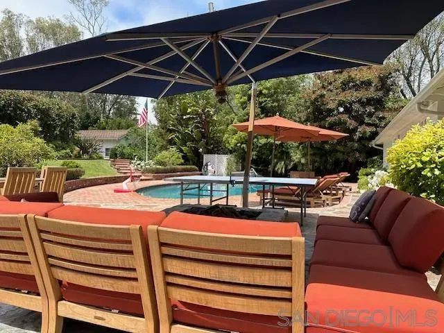 a patio with a patio table and chairs under an umbrella