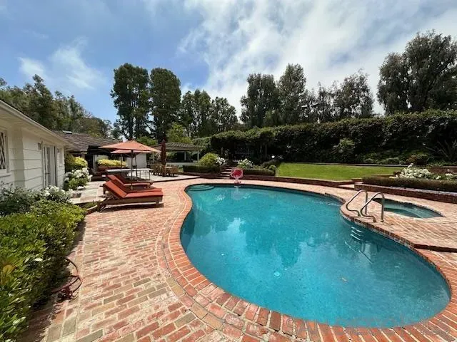 a view of a swimming pool with a bench in a porch