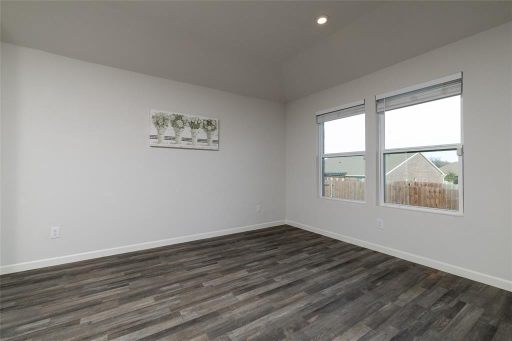 953 Ben Drive Springtown, TX 76082 - Photo 19 of 38 a view of an empty room with wooden floor and a window