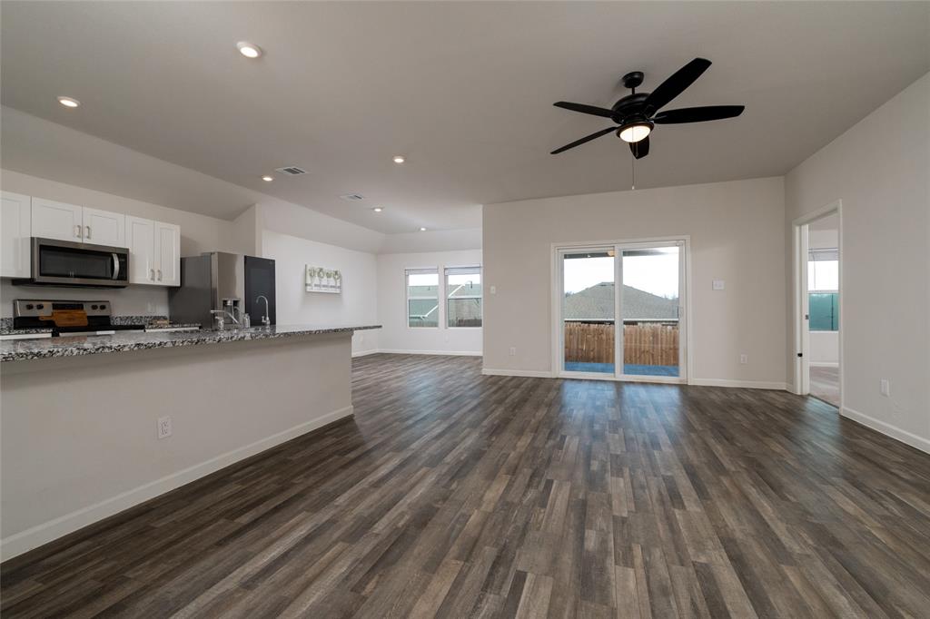 953 Ben Drive Springtown, TX 76082 - Photo 10 of 38 a view of empty room with wooden floor and window