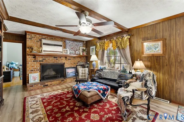 a living room with furniture a fireplace and a floor to ceiling window