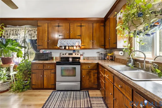 a kitchen with stainless steel appliances granite countertop a sink stove and cabinets