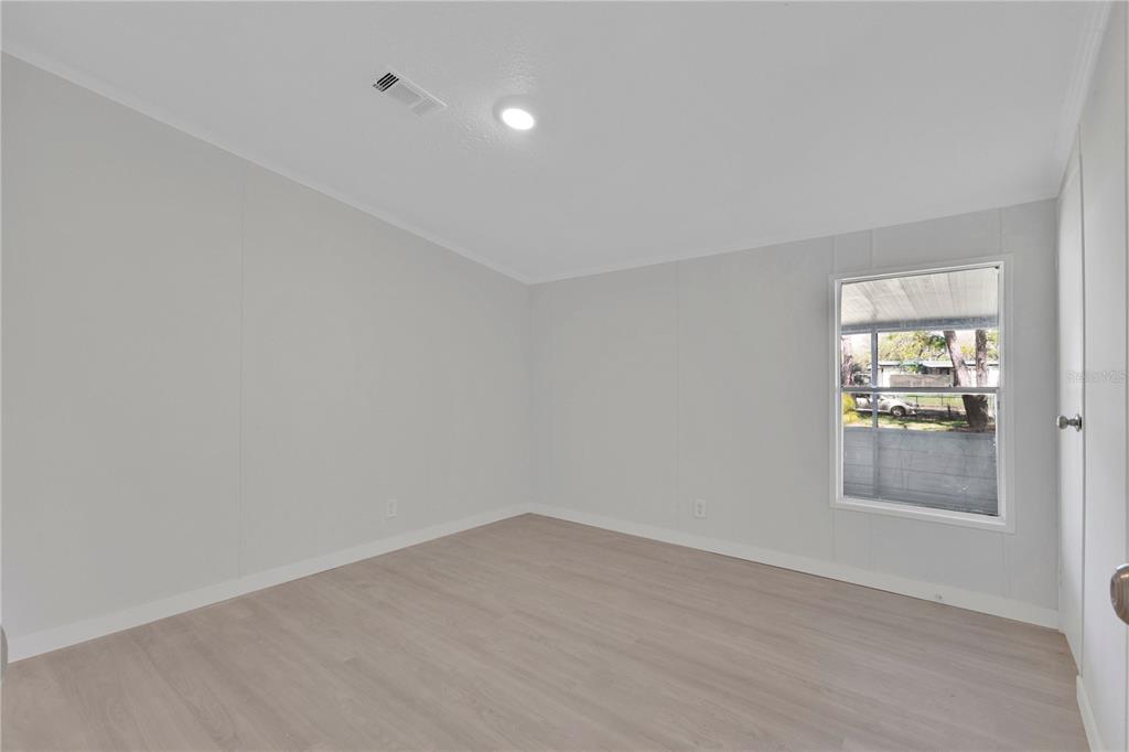 9180 Concord Road St. Cloud, FL 34773 - Photo 11 of 23 wooden floor in an empty room with a window