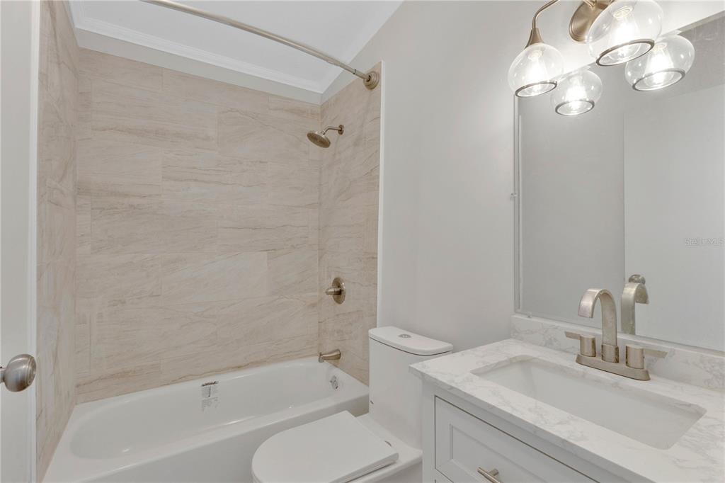 9180 Concord Road St. Cloud, FL 34773 - Photo 12 of 23 a bathroom with a sink a toilet and shower