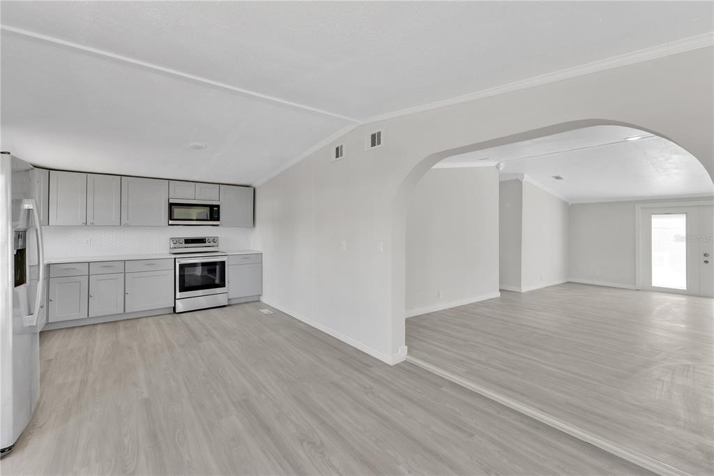 9180 Concord Road St. Cloud, FL 34773 - Photo 5 of 23 a view of a kitchen with wooden floor and a sink
