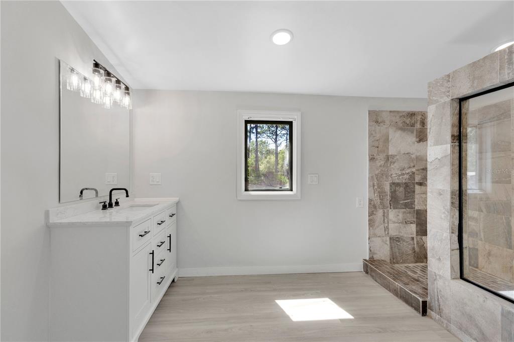 9180 Concord Road St. Cloud, FL 34773 - Photo 8 of 23 a bathroom with a sink mirror and shower