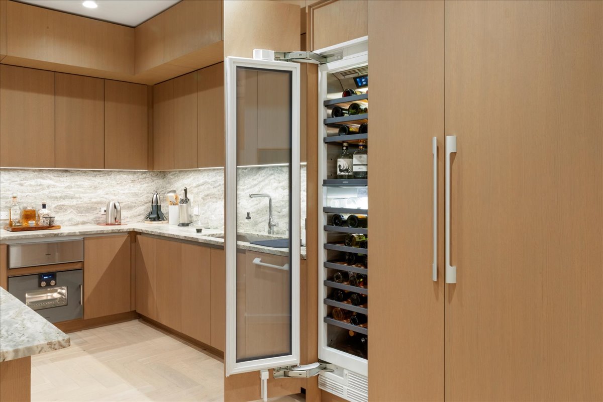 313 West 17th Street, Unit 1104 Austin, TX 78701 - Photo 12 of 40 A showcase of fully integrated Gaggenau® refrigeration, including 36” refrigerator, 18” freezer and 18” wine column, all concealed within custom Rhode Partners millwork for a seamless, architectural look. The 3cm Fantasy Brown marble surfaces and built-in steam oven complete a kitchen designed for both elevated entertaining and everyday ease.