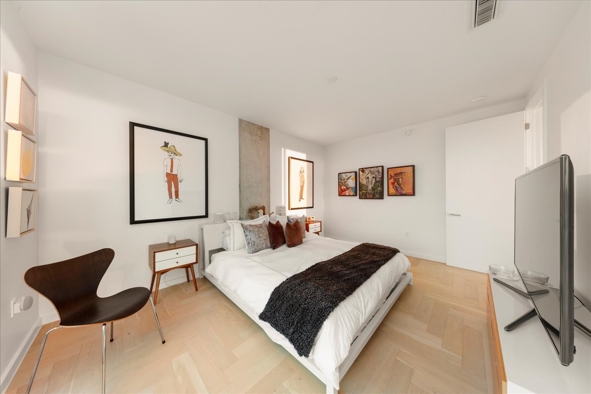 313 West 17th Street, Unit 1104 Austin, TX 78701 - Photo 16 of 40 The tranquil space features warm wood accents, soft neutral tones, and thoughtful lighting that complements the natural glow of golden hour, offering the perfect retreat after a busy day.