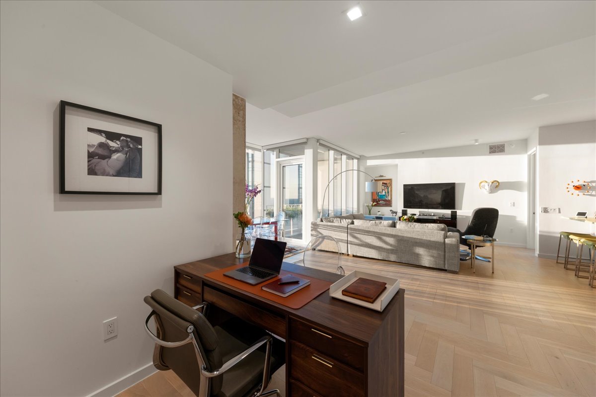 313 West 17th Street, Unit 1104 Austin, TX 78701 - Photo 7 of 40 A naturally lit flexible space that opens directly to the living and dining areas, ideal as a home office, creative studio or private library. The upgraded herringbone wood floors and clean architectural lines make it a refined extension of the residence’s custom, penthouse-level design.