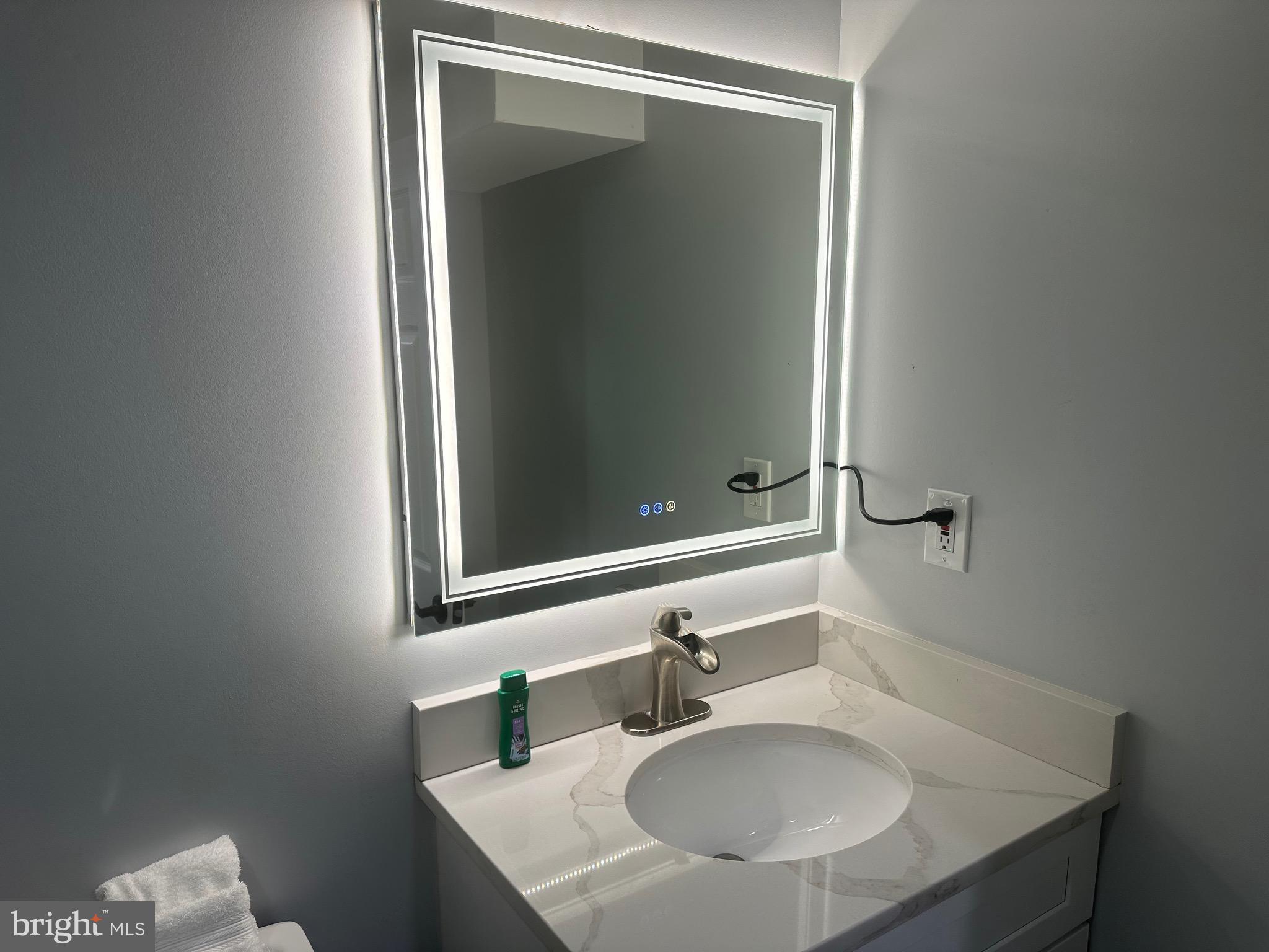 806 Sligo Avenue Silver Spring, MD 20910 - Photo 12 of 31 a bathroom with a sink and a mirror