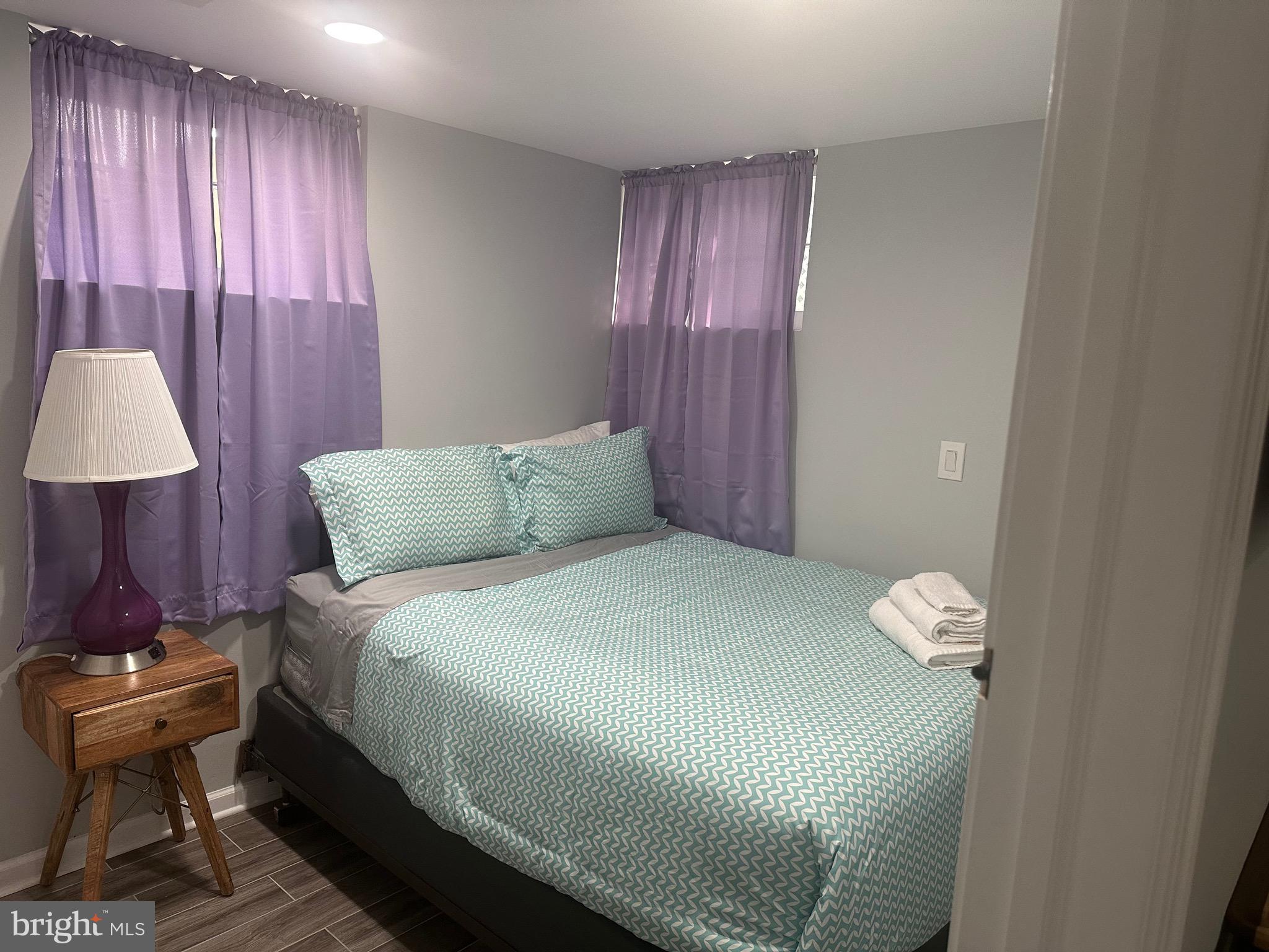 806 Sligo Avenue Silver Spring, MD 20910 - Photo 14 of 31 a bedroom with a bed and a lamp on dresser