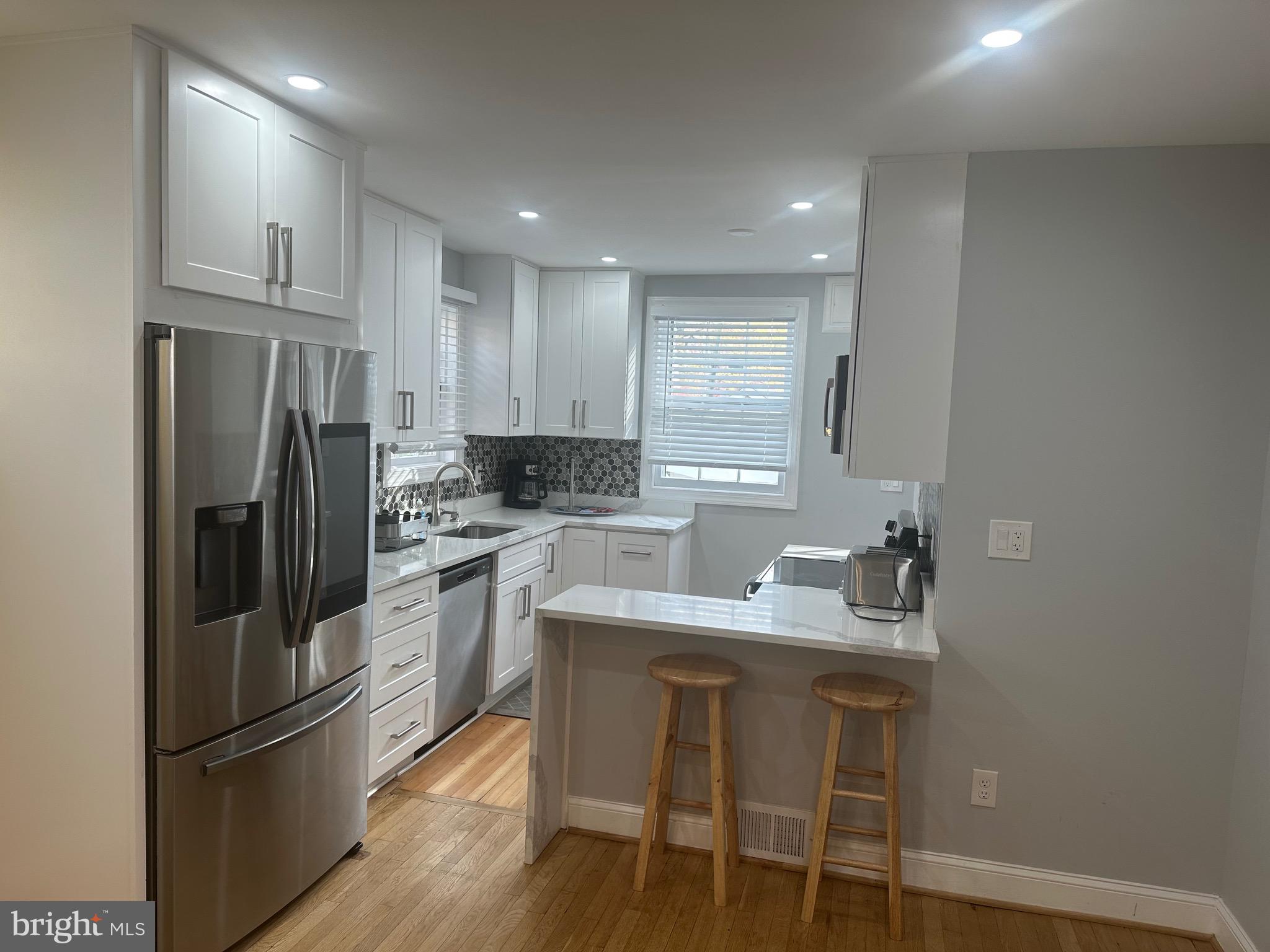 806 Sligo Avenue Silver Spring, MD 20910 - Photo 6 of 31 a kitchen with a refrigerator a sink and cabinets