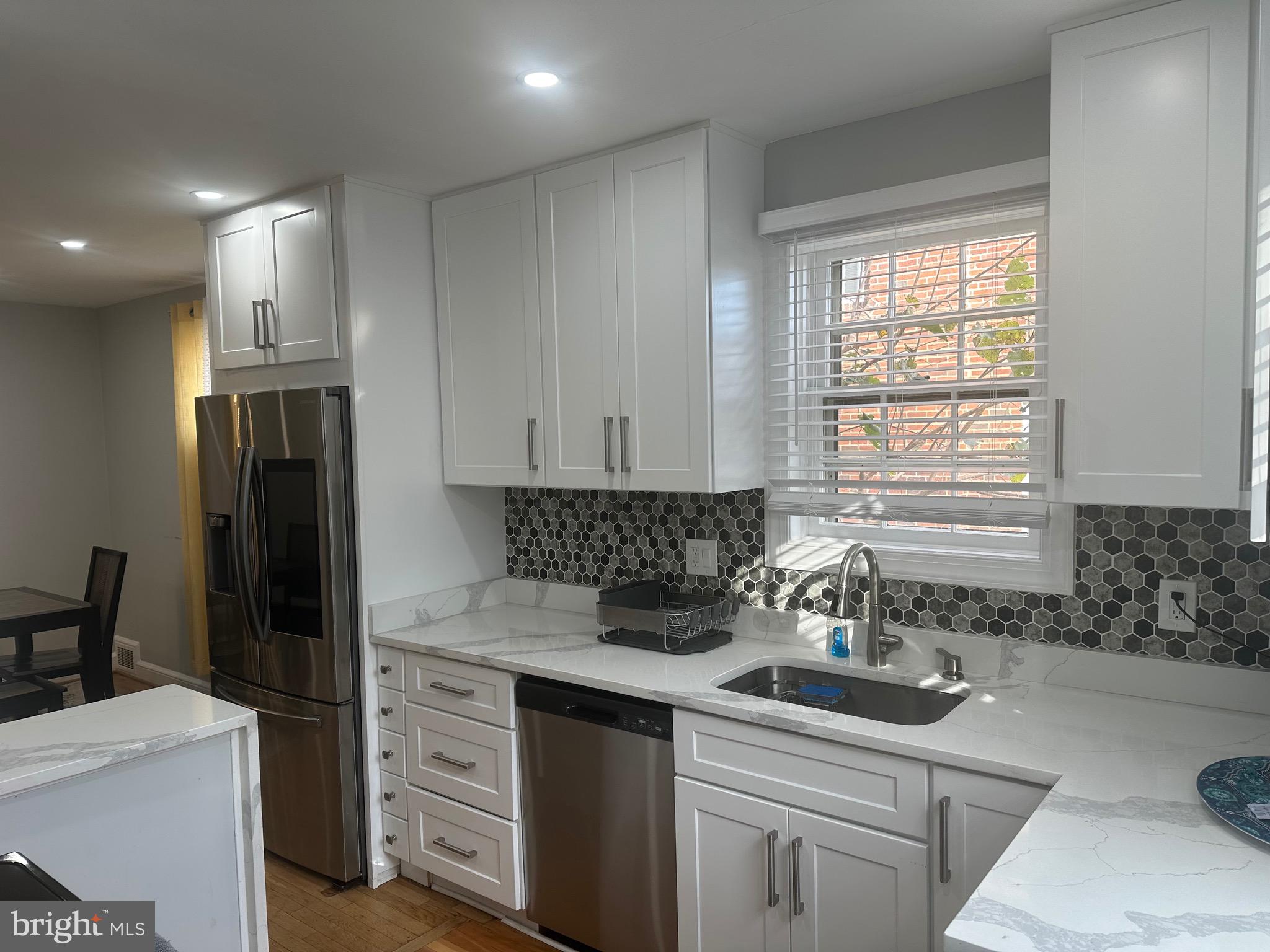806 Sligo Avenue Silver Spring, MD 20910 - Photo 7 of 31 a kitchen with a sink stove and refrigerator
