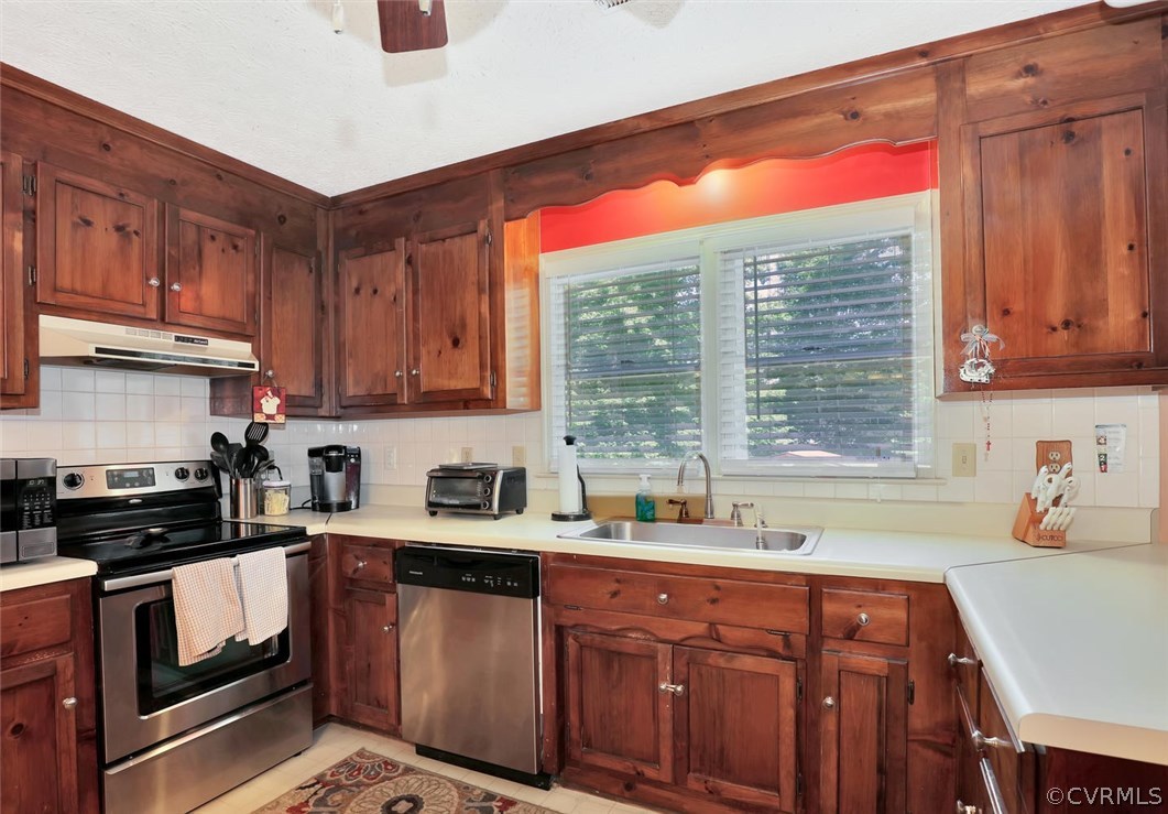 2606 Iverson Road Midlothian, VA 23112 - Photo 7 of 19 a kitchen with stainless steel appliances granite countertop a sink stove and cabinets