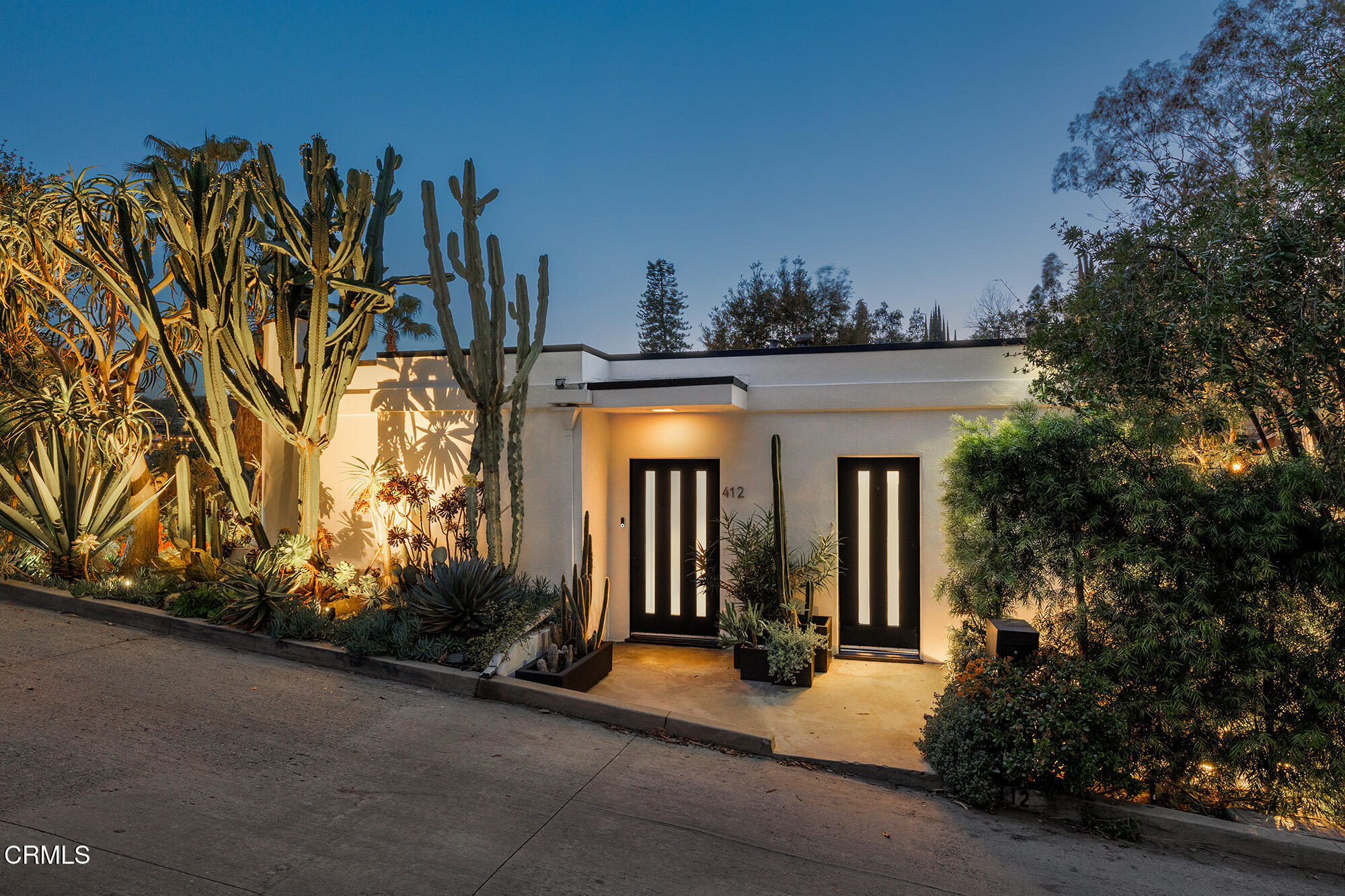 412 Glen Holly Drive Pasadena, CA 91105 - Photo 16 of 18 a view of a house with potted plants and large trees