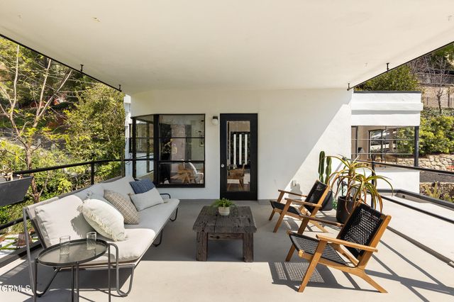 a living room with furniture and large windows
