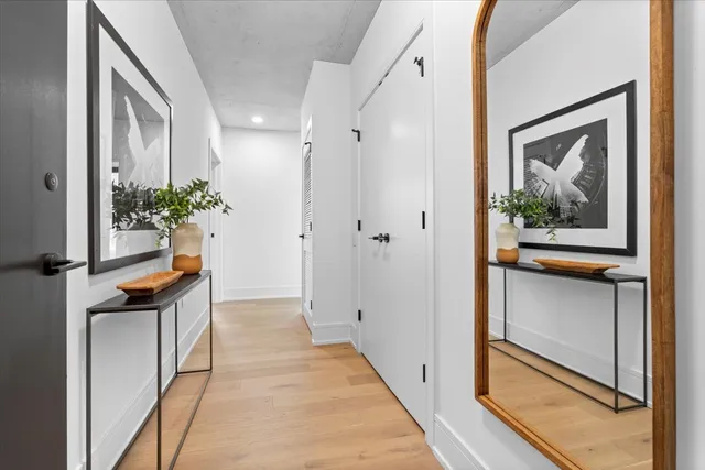 a hallway with sliding door and wooden floor