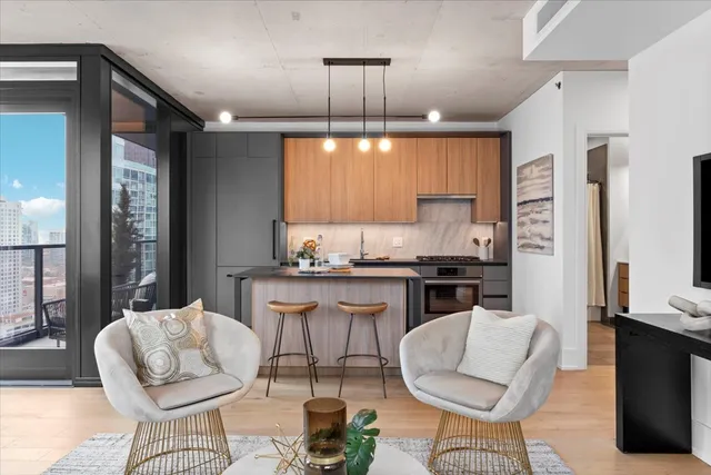 a kitchen with a dining table chairs stainless steel appliances and cabinets