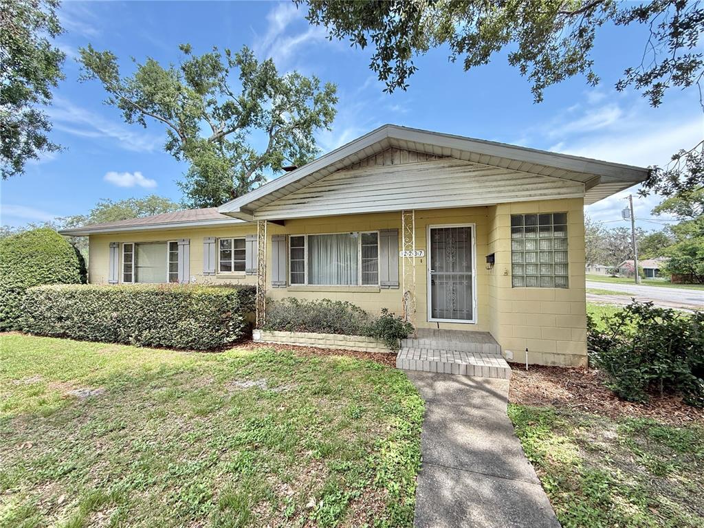 a front view of house with yard and green space