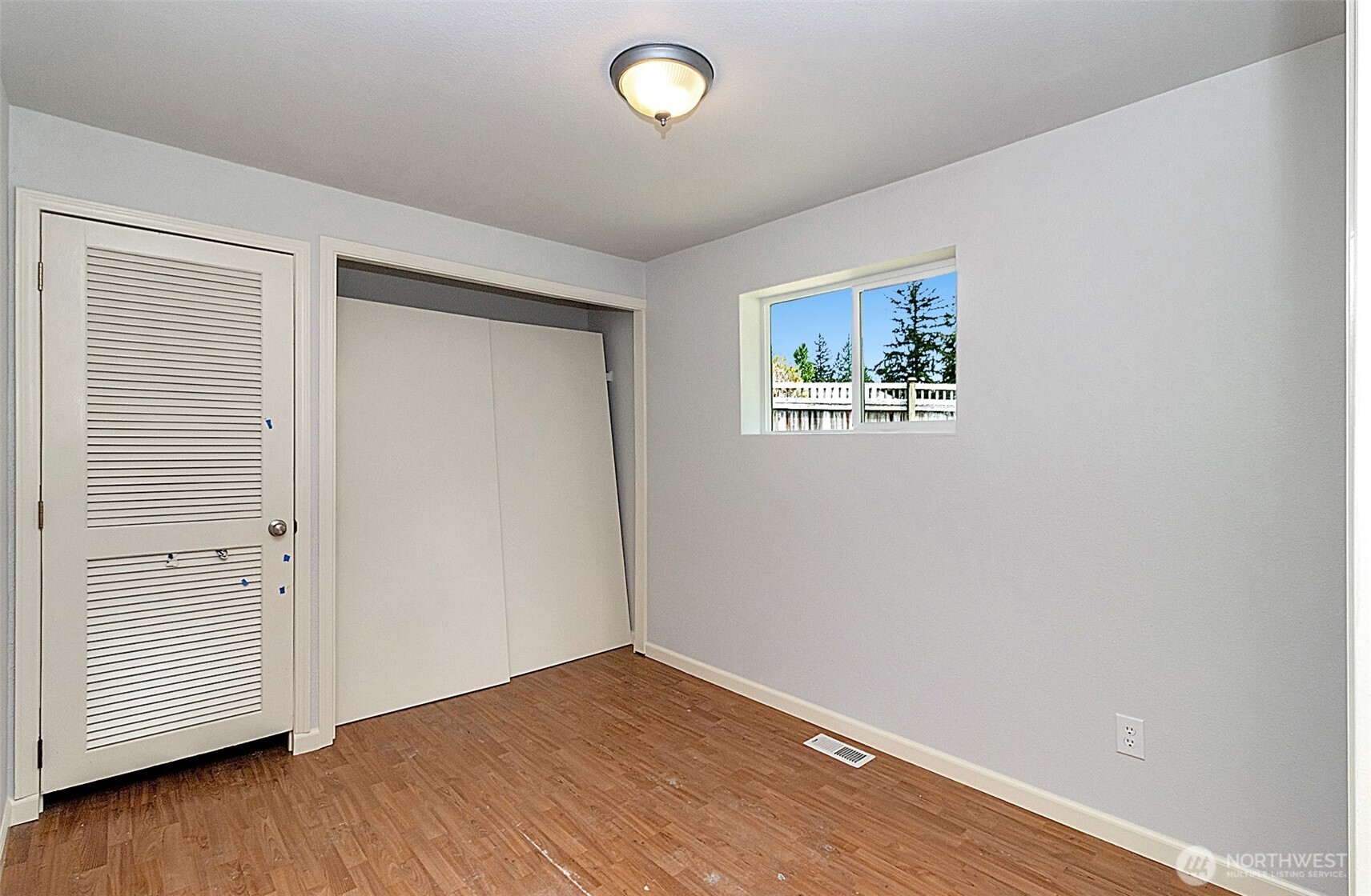 2325 Cherry Road, Unit B Lake Stevens, WA 98258 - Photo 12 of 13 an empty room with wooden floor and windows
