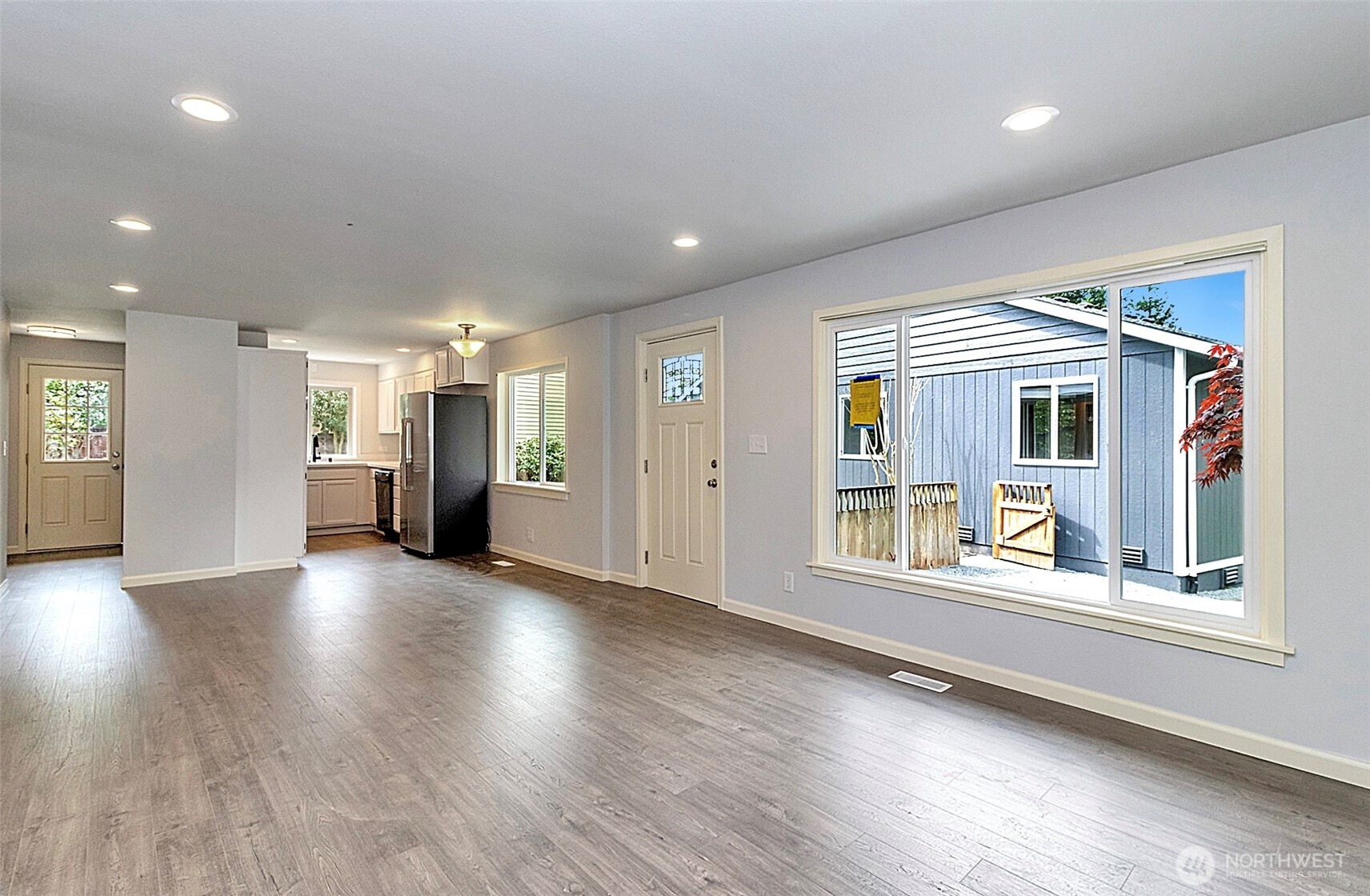 2325 Cherry Road, Unit B Lake Stevens, WA 98258 - Photo 4 of 13 an empty room with wooden floor and windows