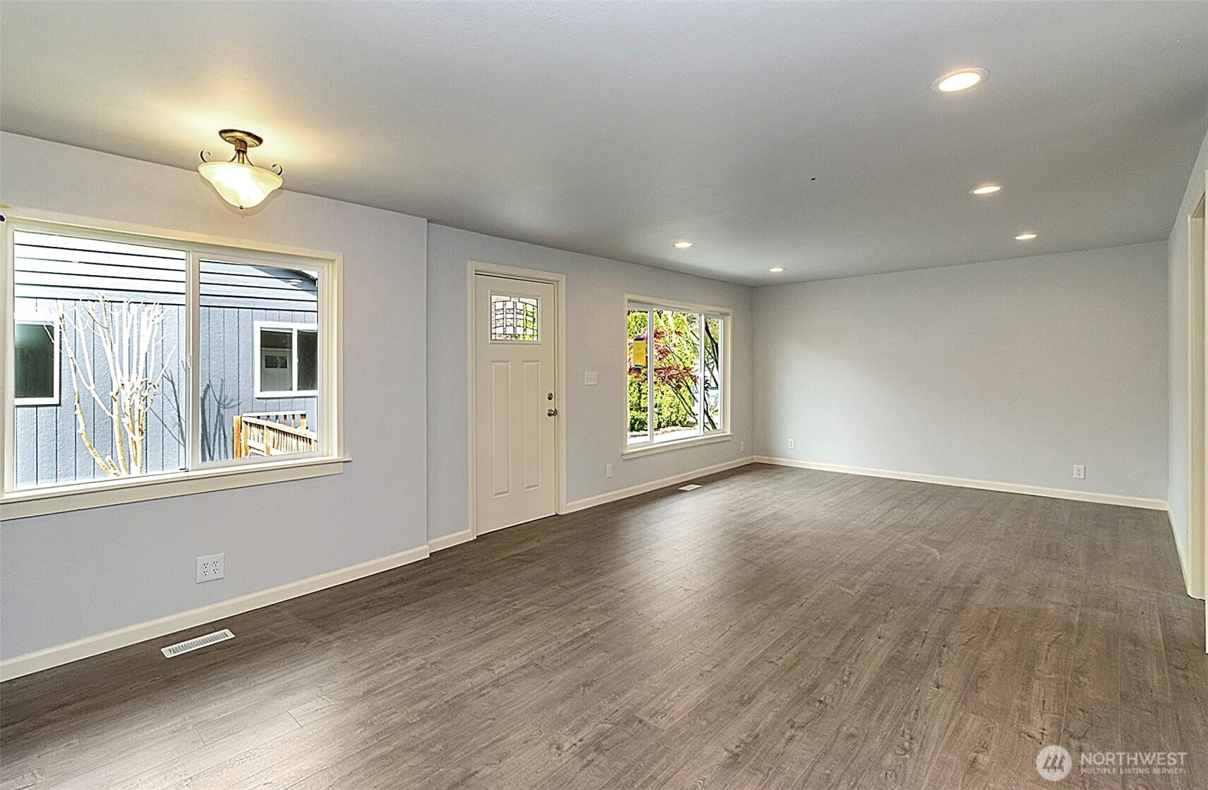 2325 Cherry Road, Unit B Lake Stevens, WA 98258 - Photo 5 of 13 an empty room with wooden floor and windows