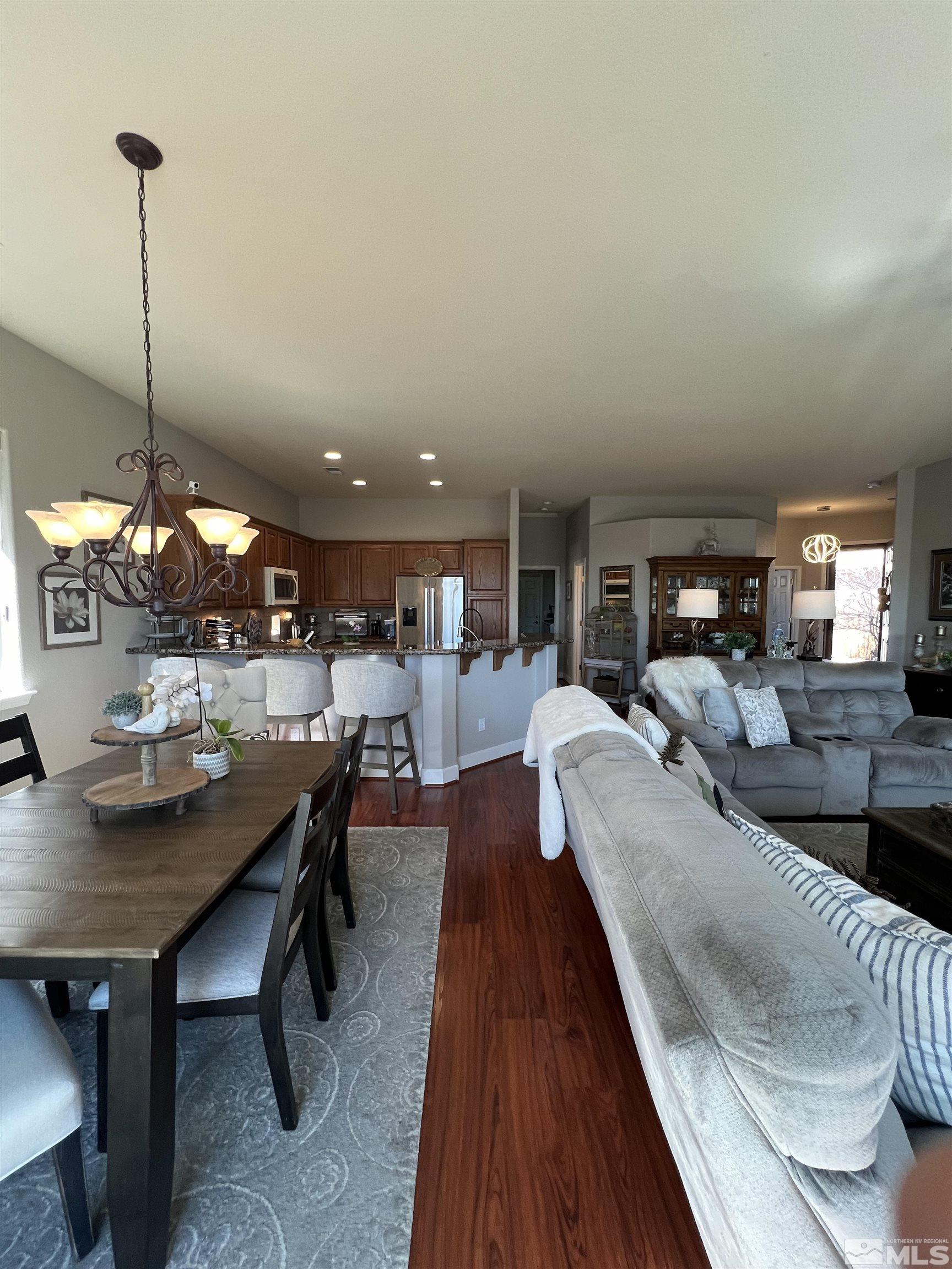 1085 Tee Drive Minden, NV 89423 - Photo 14 of 29 a living room with furniture a rug and a chandelier