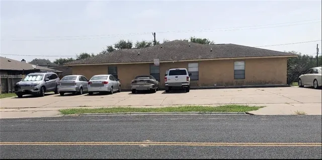 a couple of cars parked in front of house