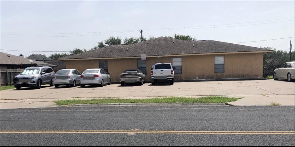 a couple of cars parked in front of house