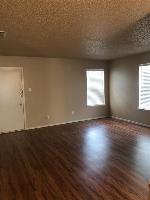 3734 Lott Avenue, Unit 4 Corpus Christi, TX 78410 - Photo 2 of 7 an empty room with wooden floor and windows