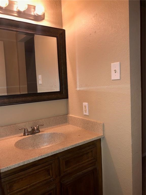 3734 Lott Avenue, Unit 4 Corpus Christi, TX 78410 - Photo 7 of 7 a bathroom with a sink and a mirror
