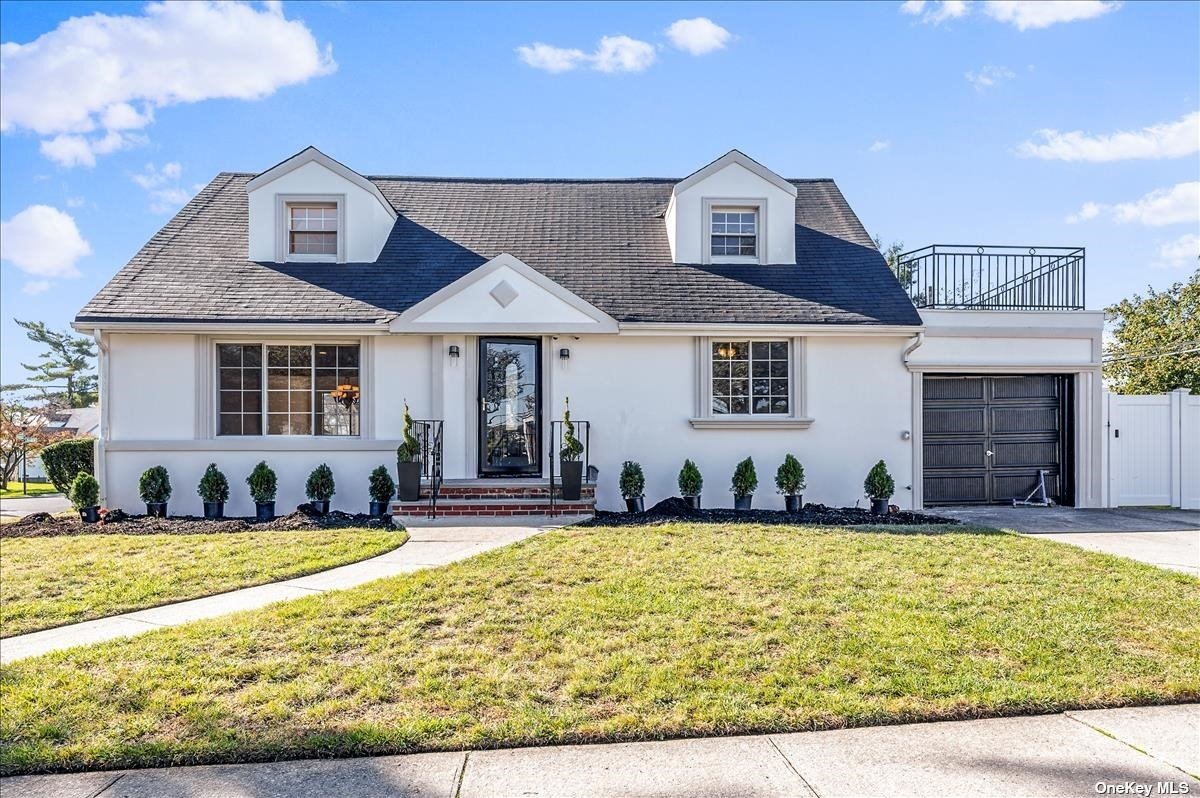 1046 March Drive Valley Stream, NY 11580 - Photo 1 of 1 a front view of a house with a yard outdoor seating and garage
