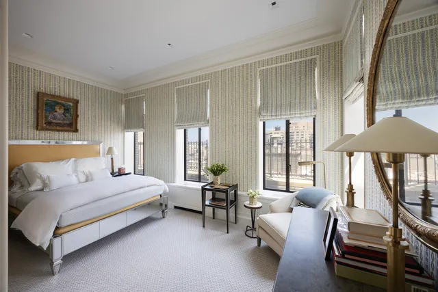 a living room with a large bed and a large window